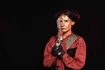 Woman Holding Pistol Isolated on Black