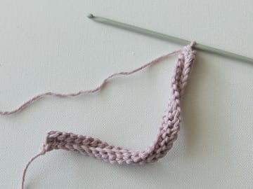 Work the Tunisian simple stitch for 25 or 28 rows until your piece is square