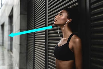 Side view of sporty woman listening to music.