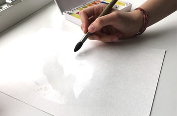 Adding water to the watercolor paper