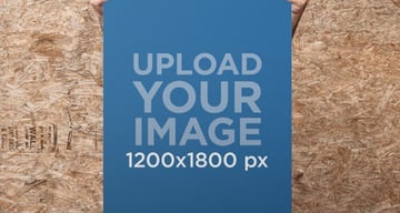 Guy Standing in Front of a Wooden Wall Holding a Poster Mockup