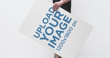 Poster Mockup of a Young Man Holding a Poster