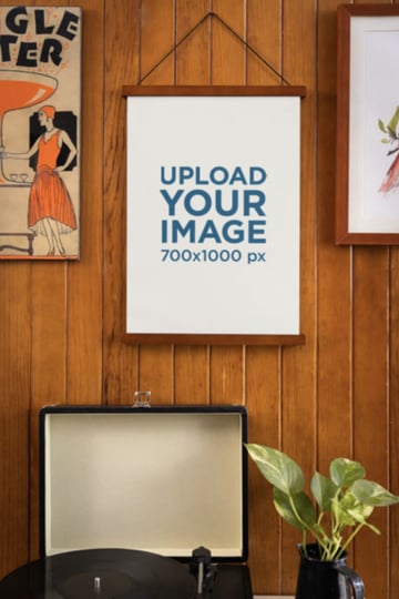Movie Poster Mockup Hanging on a Wooden Wall Featuring an Old Record Player