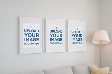 Mockup of Three Poster Frames Hanging on a Living Room Wall