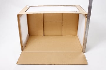 Measuring the other edge of the cardboard box