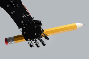 robot arm holding pencil