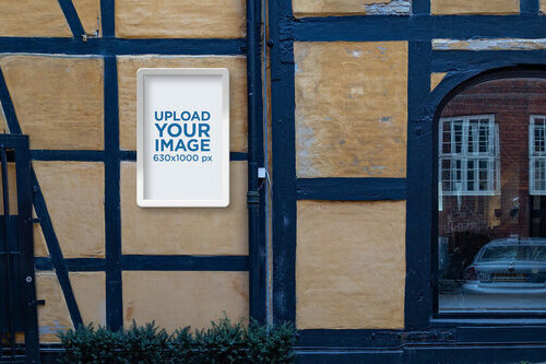 Poster Display Case Mockup Featuring a Worn Block-Style Wall