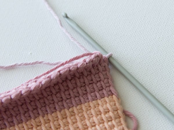 Yarn over and pull through the two loops with your new colour then continue the Tunisian simple stitch with your new colour