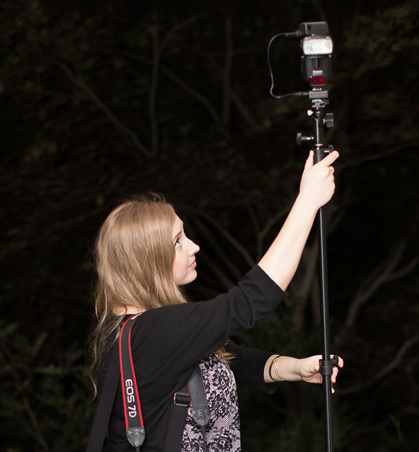 photographers assistant adjusting a flash unit