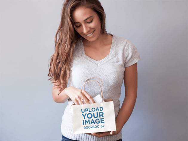 Packaging Mockup of a Young Woman Holding a Shopping Bag