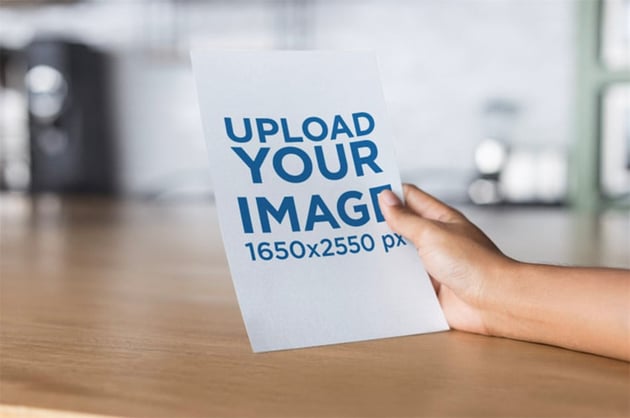 Mockup of Hand Holding a Flyer