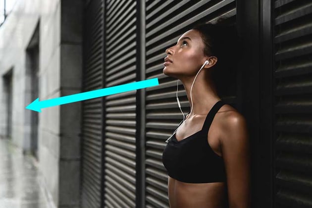 Side view of sporty woman listening to music.