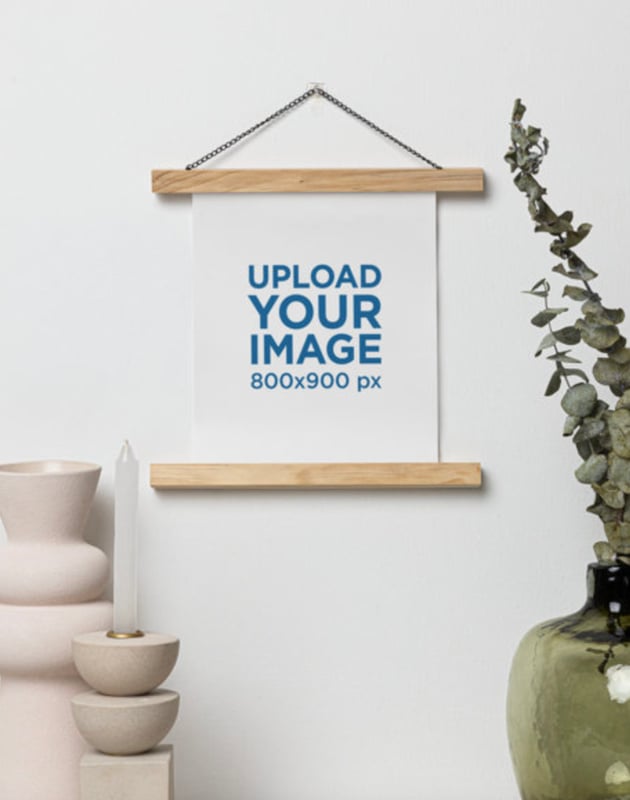 Mockup of a Matte Vertical Poster Hanging on a Wall Featuring Modern Decorations