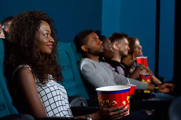 people watching a movie with popcorn
