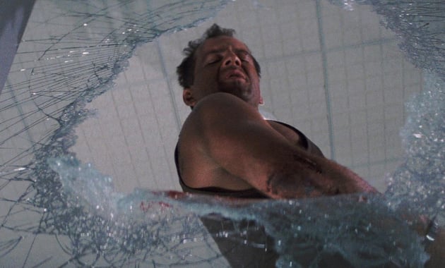 McClane looking through broken glass from Die Hard