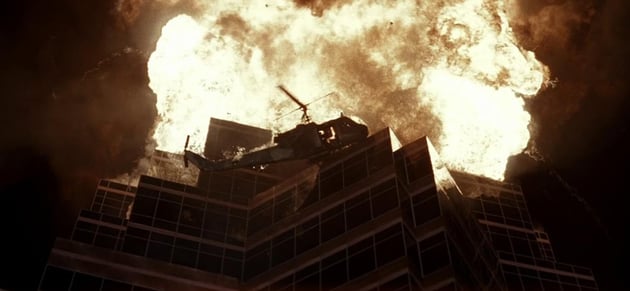nakatomi plaza on fire with a helicopter in the foreground