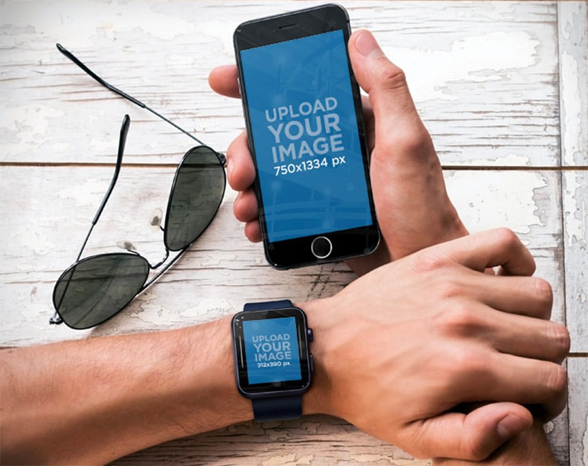 Top Shot of Man Holding iPhone 6 and Wearing a Black Apple Watch