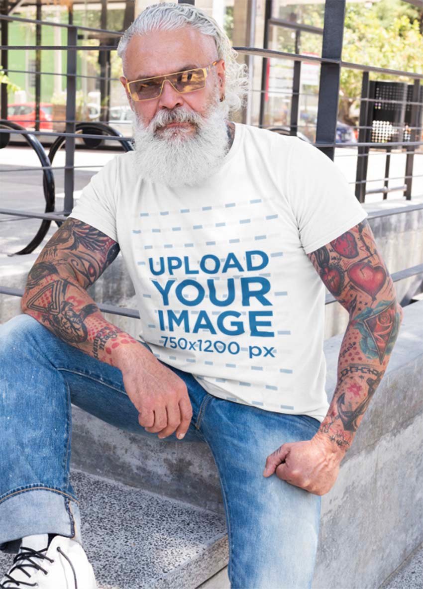 T-Shirt Mockup of a Senior Tattooed Man with Sunglasses