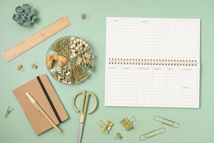 Mockup of weekly planner and office stationery
