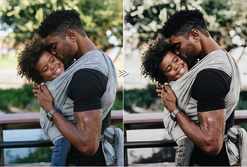 Portrait of man carrying a child.