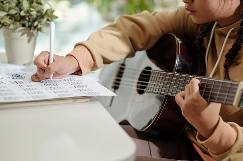 Girl Writing Music Notes