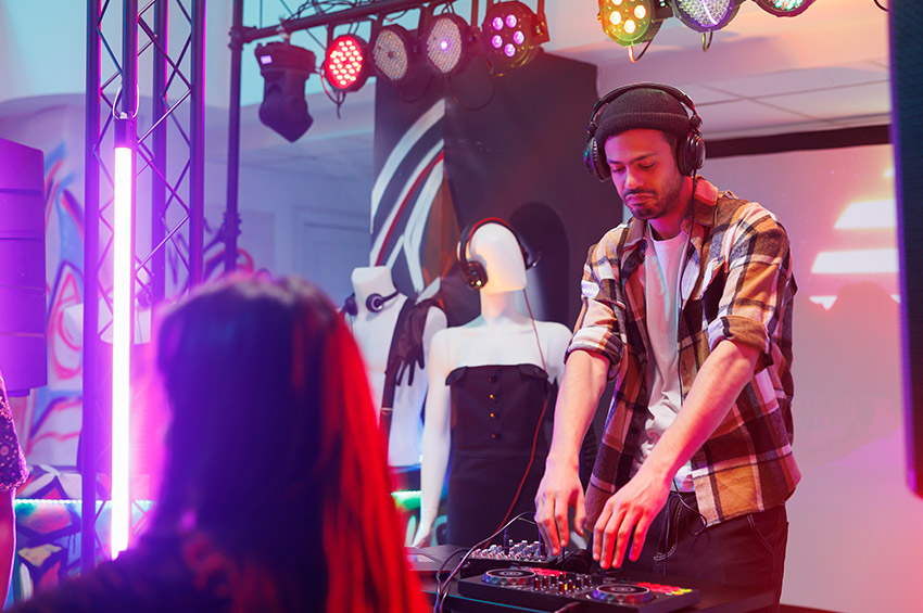 Dj in headphones mixing tracks