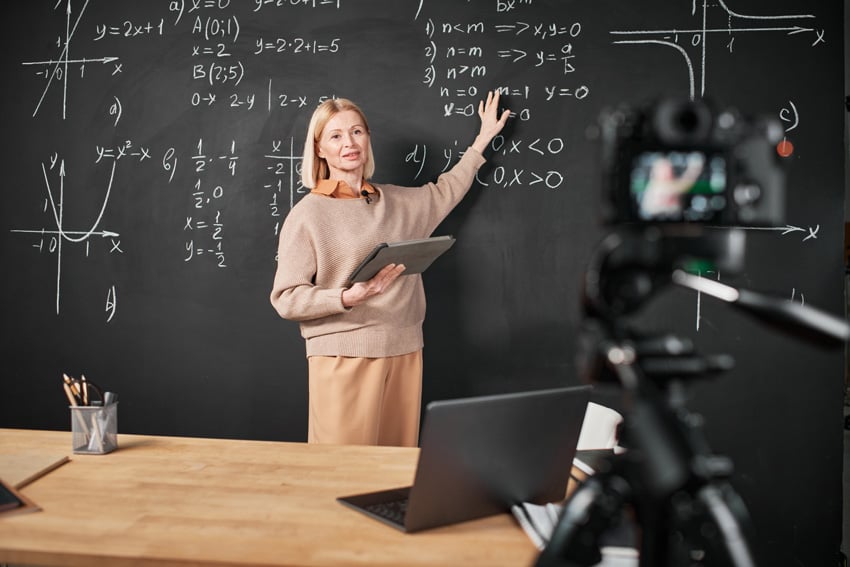 teacher explaining at a blackboard