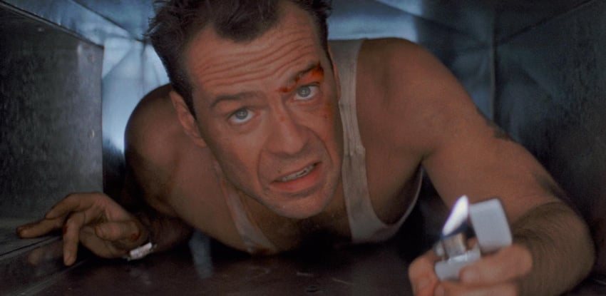 McClane crawls through an air vent with a lighter