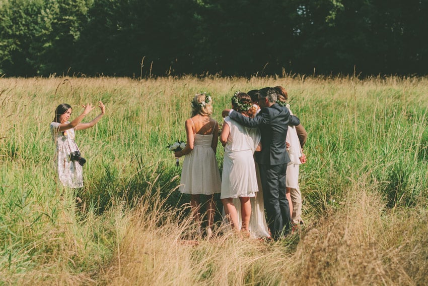 A wedding photographer photographing a group shot at a wedding