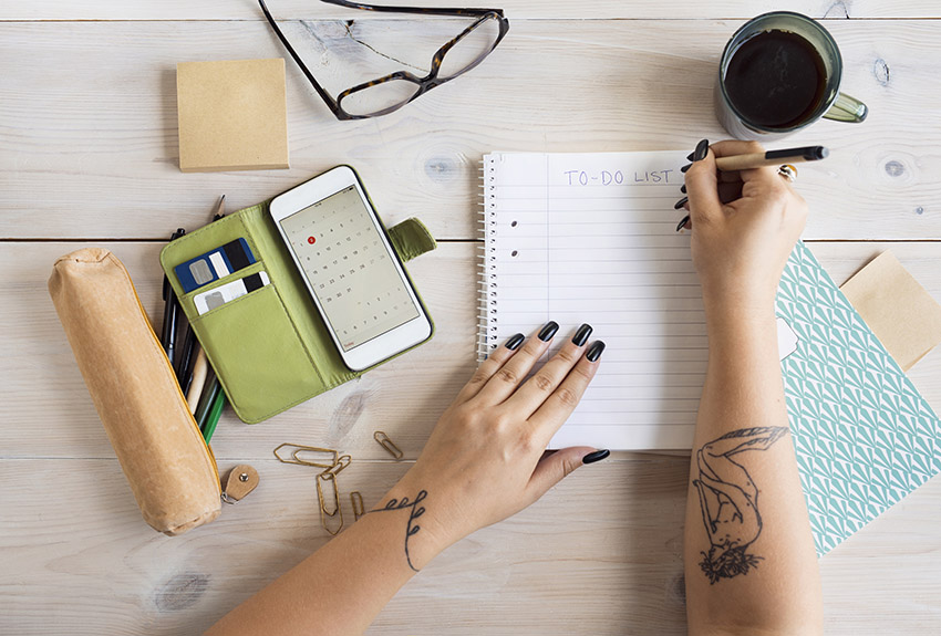 Woman preparing to-do-list in office